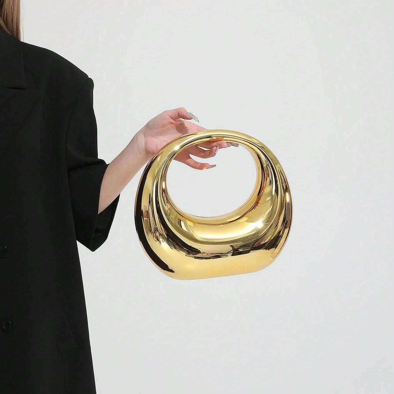 Woman holding gold ring handle clutch bag – ARLANA
