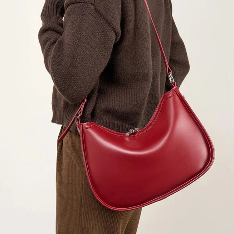 Woman carrying brown crescent shoulder bag – ARLANA