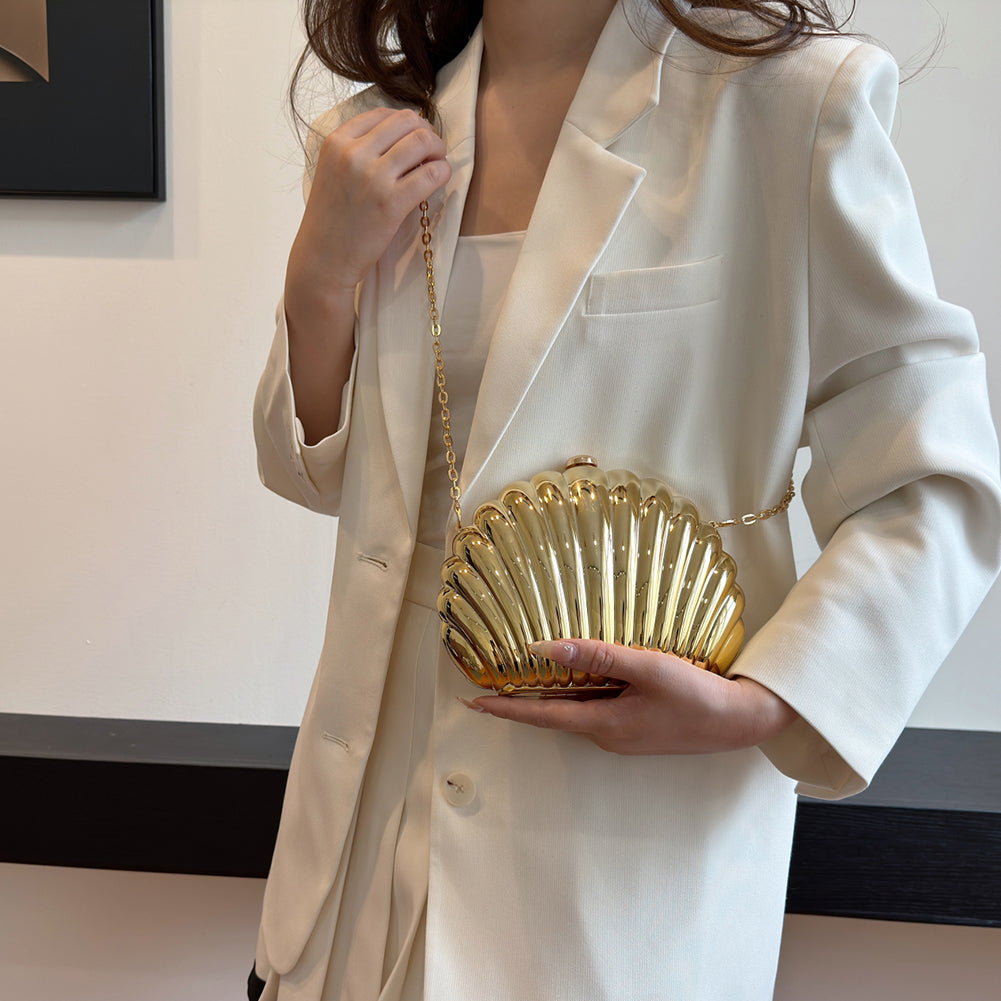 Woman carrying shell shaped gold clutch crossbody bag – ARLANA
