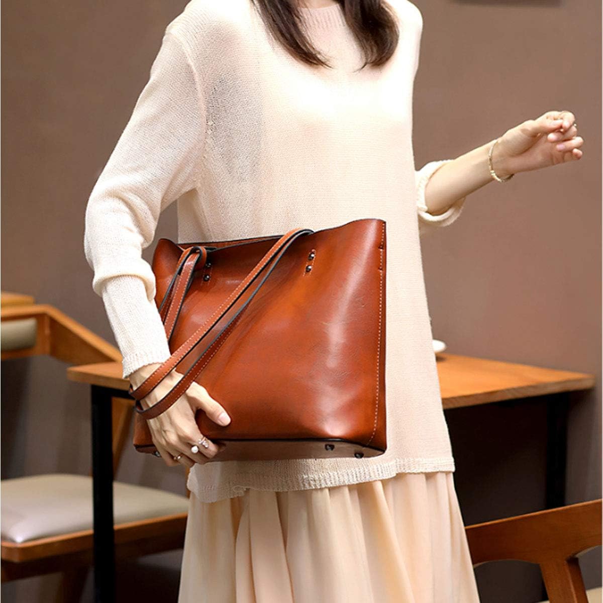 Woman carrying large vegan leather tote over shoulder – ARLANA
