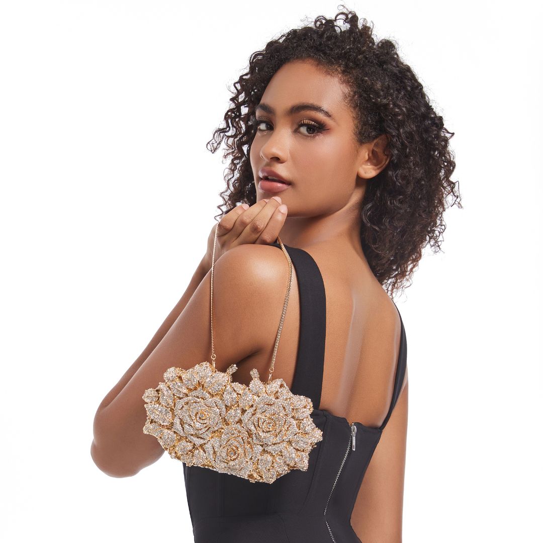 Woman holding gold 3D floral rose clutch at formal event – ARLANA