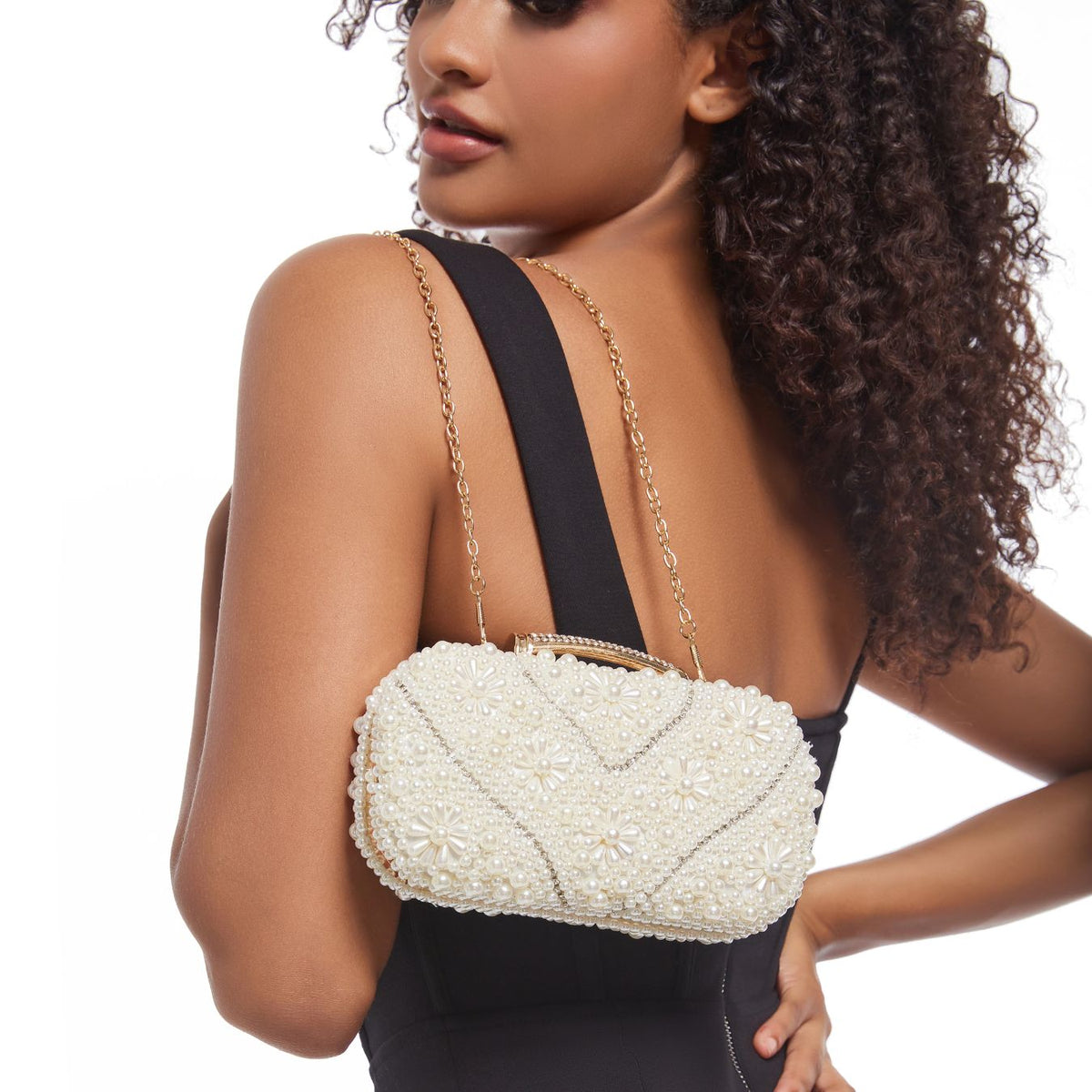 Woman holding pearl beaded quilted clutch at formal event – ARLANA