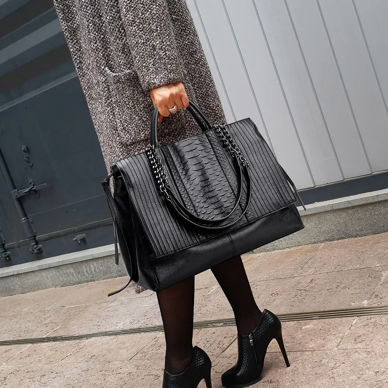 Woman carrying croc embossed black tote on shoulder – ARLANA